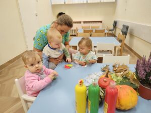 Dzieci bawią się Woreczkami strunowymi wypełnionym farbami w jesiennych kolorach.
