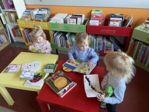 Dzieci oglądają książeczki w bibliotece