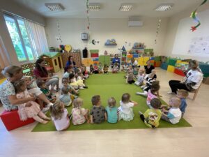Pani z biblioteki czyta książkę dzieciom.